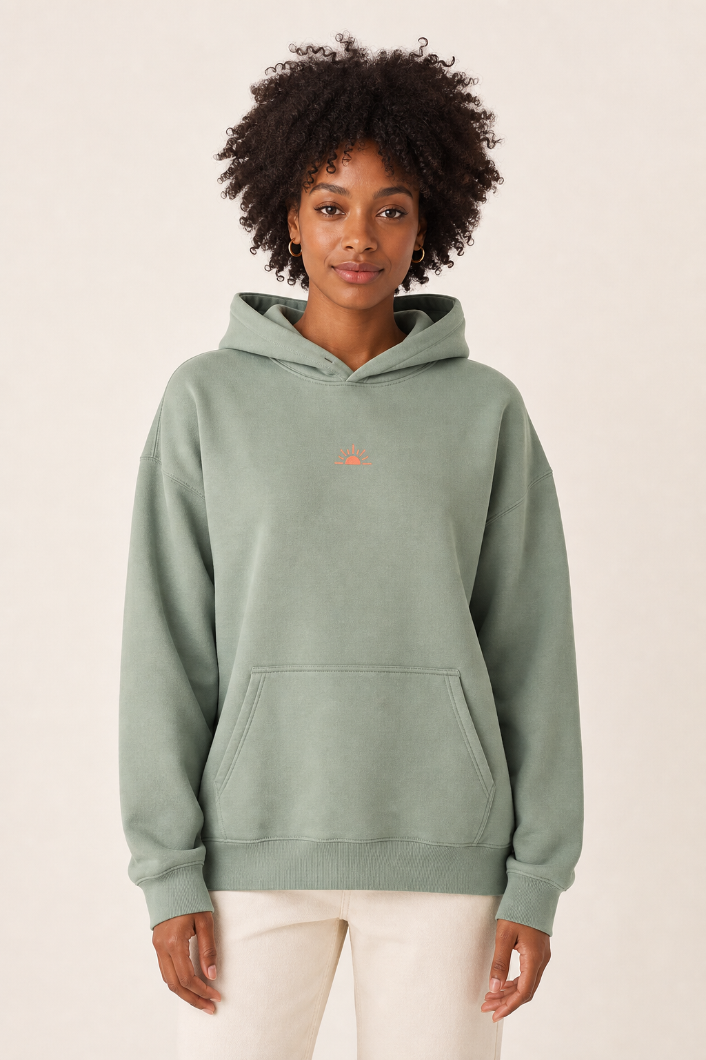 Model wearing a sage hoodie inside the PromoPlus mockup designer